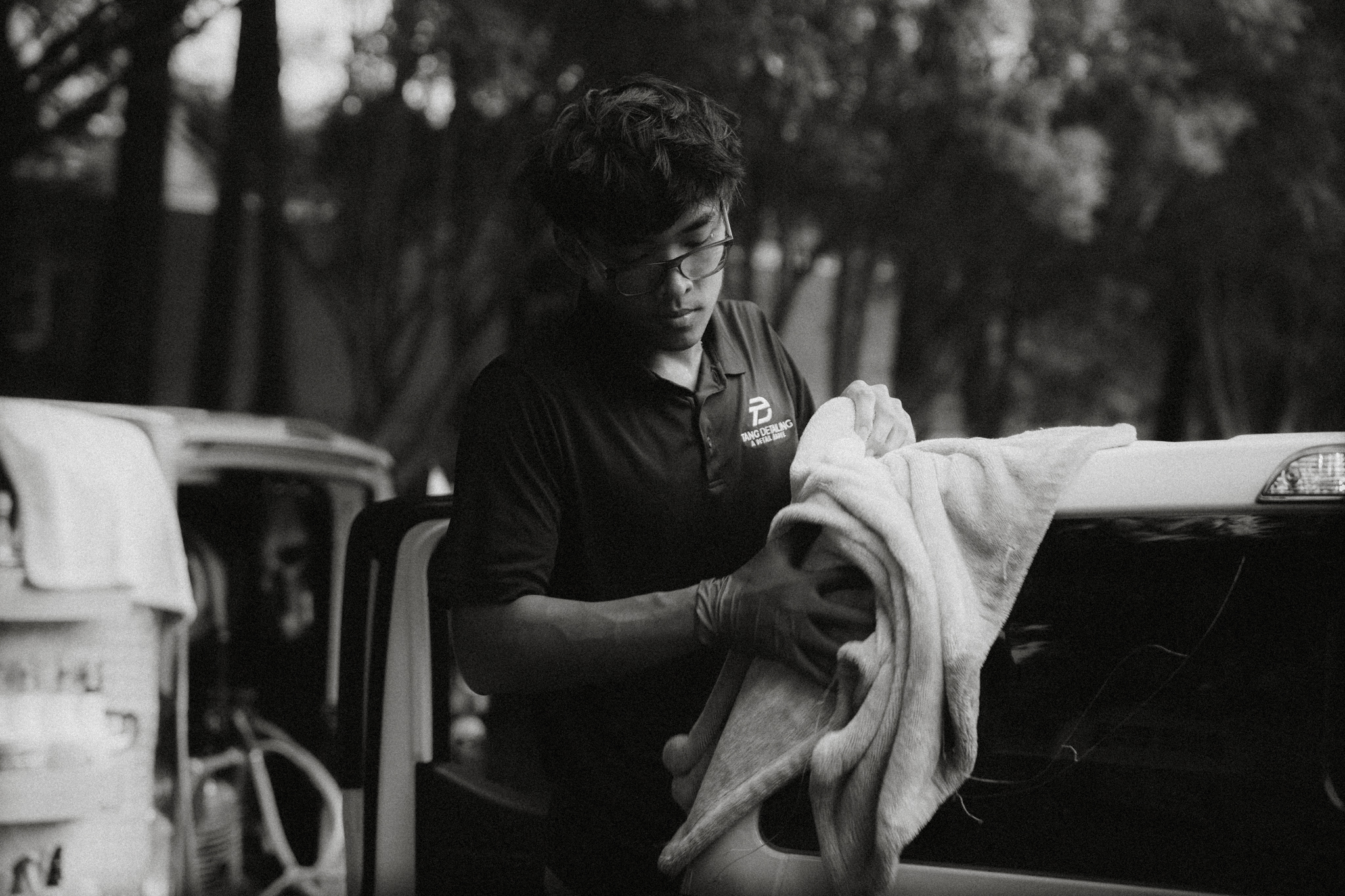 Tang Detailing technician hand-drying a vehicle in Raleigh NC