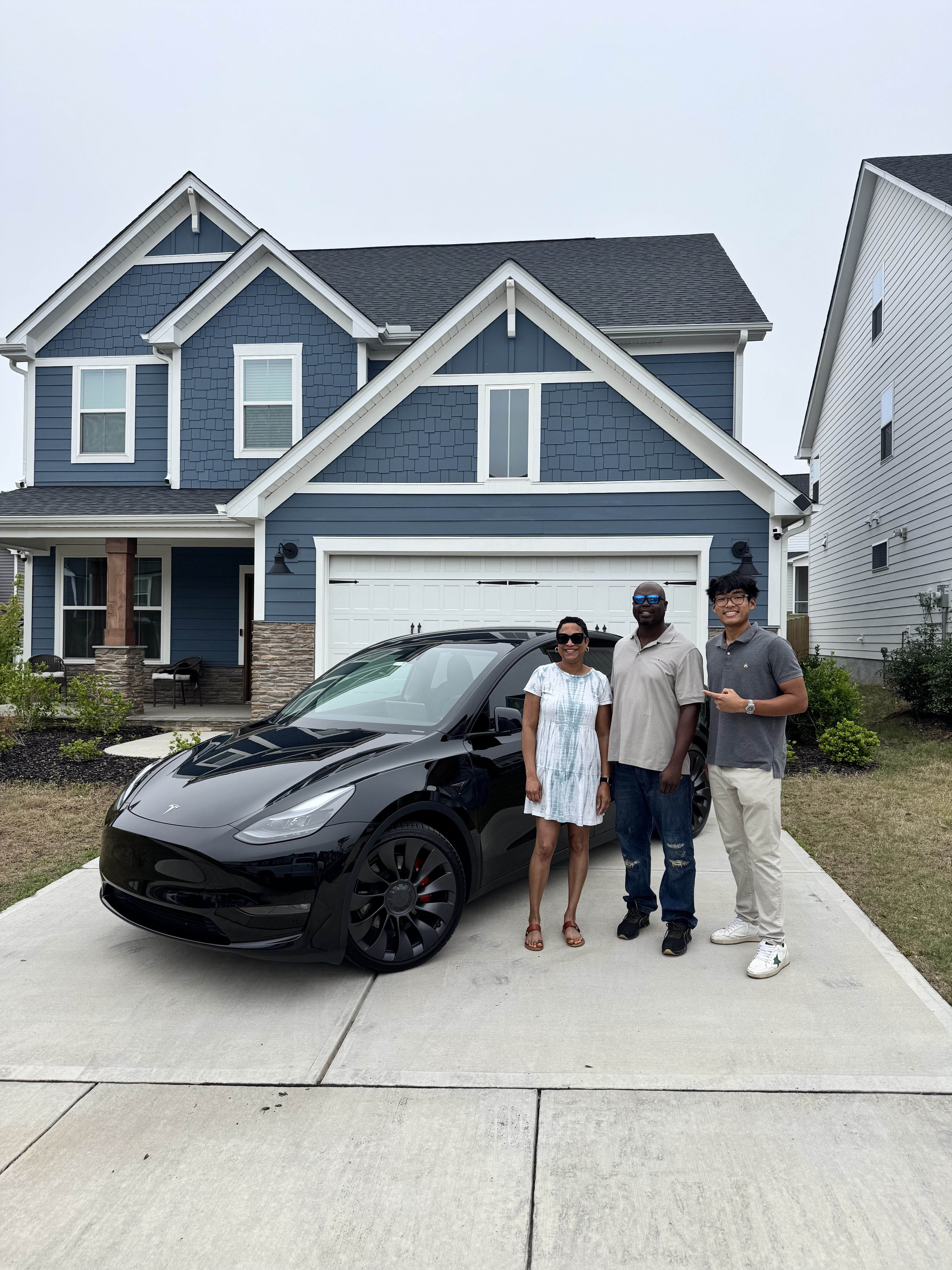 Happy Tang Detailing client with their freshly detailed vehicle in Raleigh NC