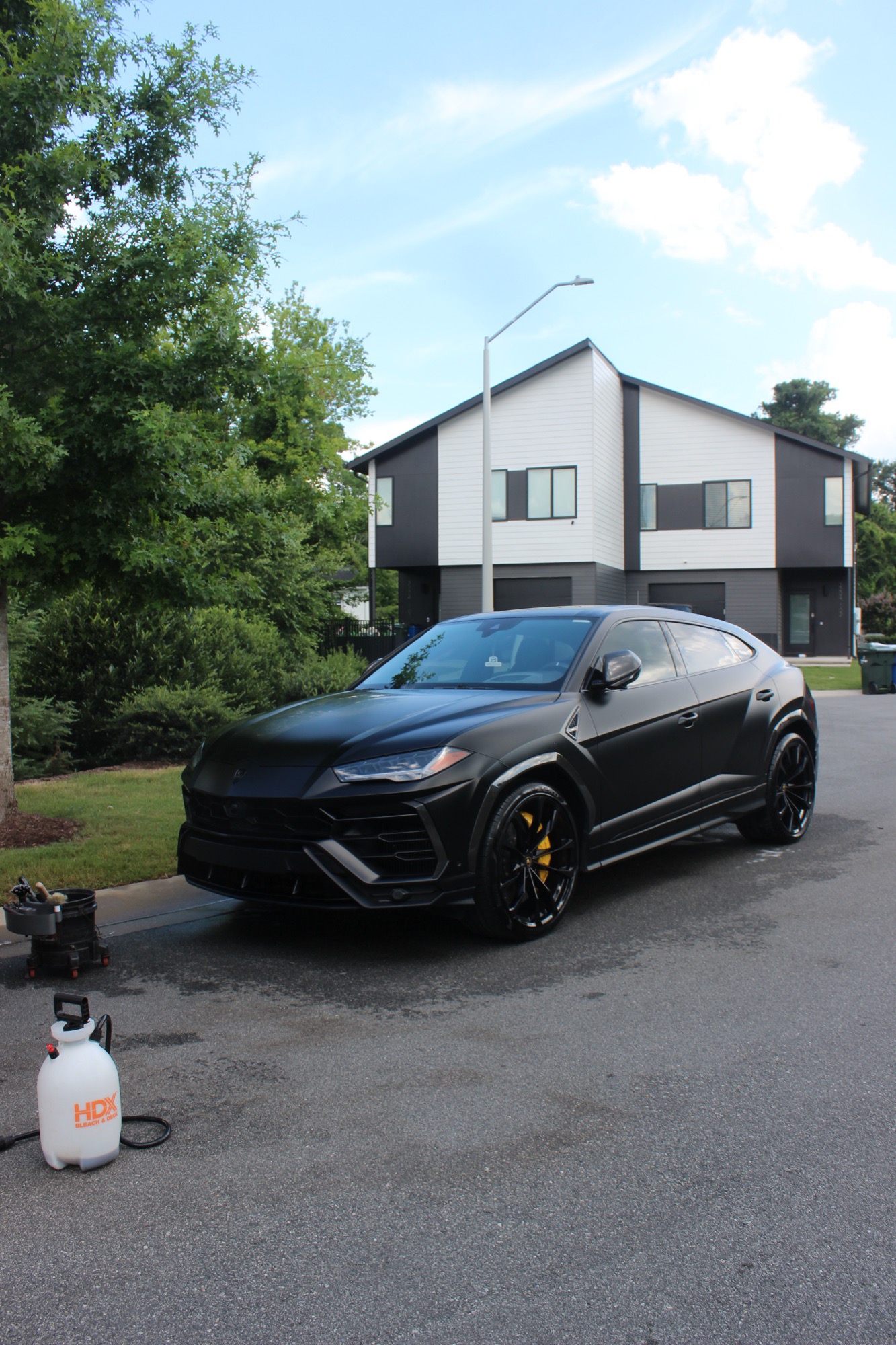 Front three-quarter view of the satin black 2024 Lamborghini Urus after its full detail in Raleigh NC
