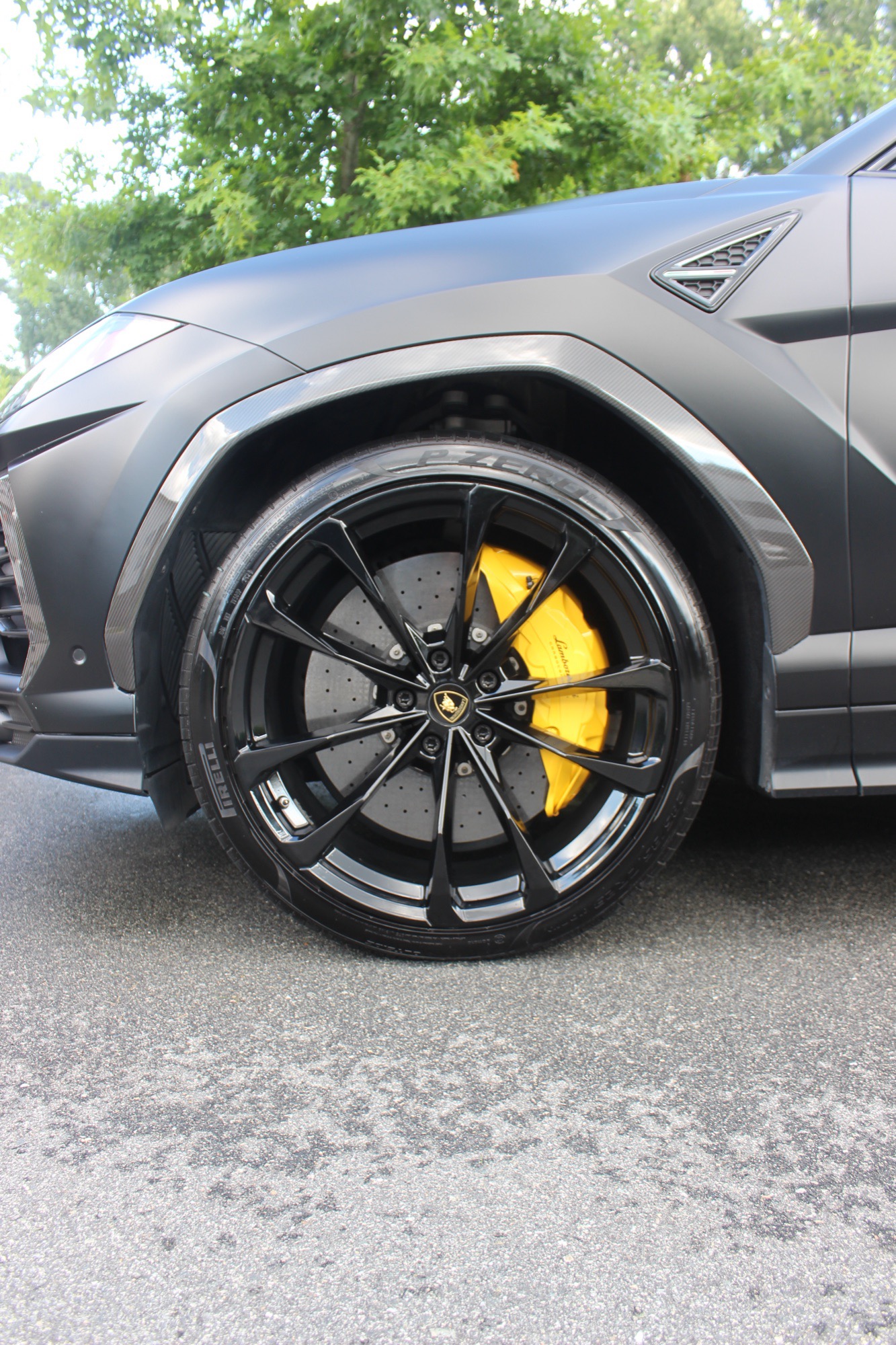 Close-up of the fully cleaned wheel and yellow Lamborghini caliper on the 2024 Urus in Raleigh NC