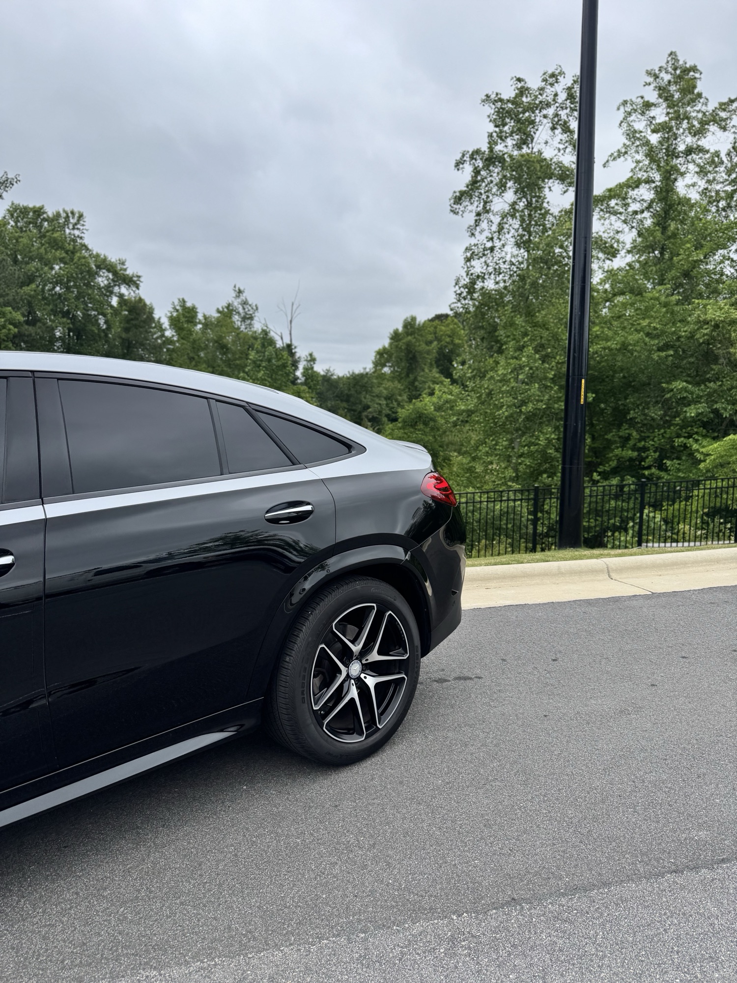 Deep black rear quarter and roofline of the 2024 Mercedes-AMG GLE Coupe reflecting after ceramic coating in Wake Forest NC