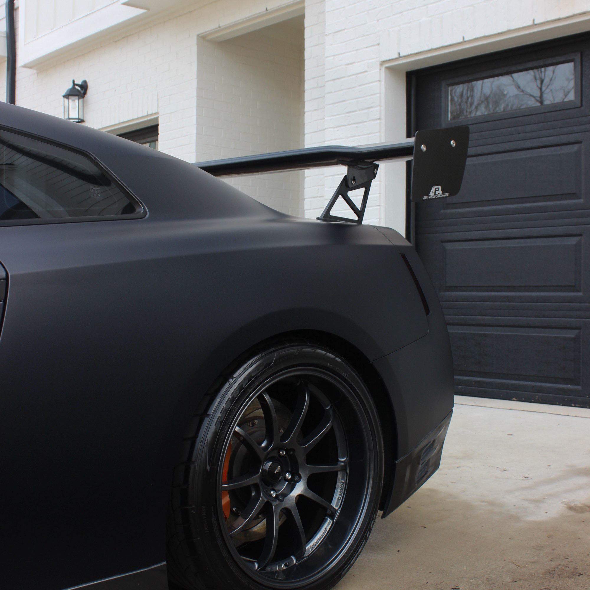 Rear quarter and wing of the matte black wrapped Nissan GT-R after a wrap-safe hand wash in Raleigh NC
