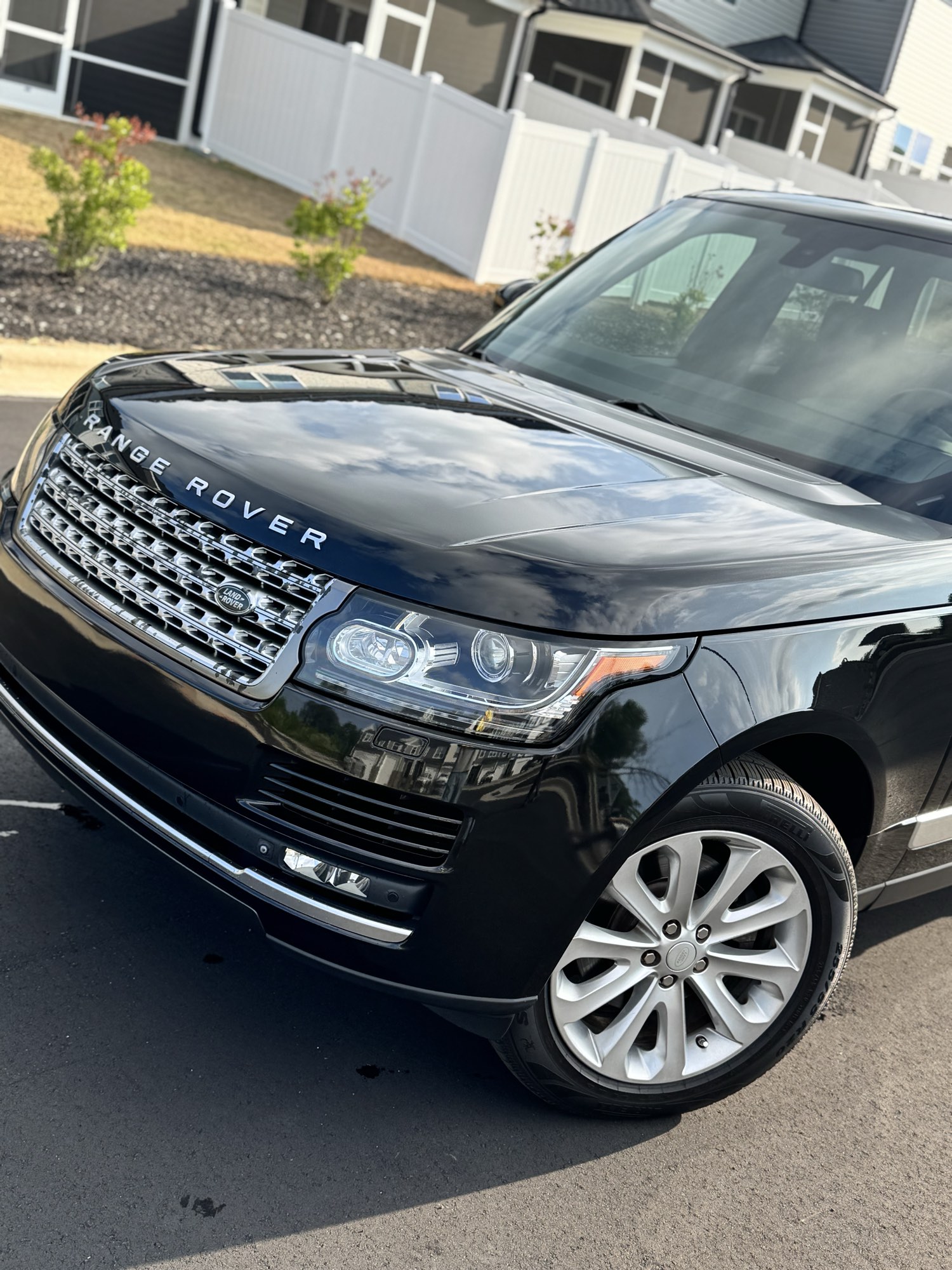 Front grille and headlight of the black 2019 Range Rover after paint correction and ceramic coating in Wake Forest NC